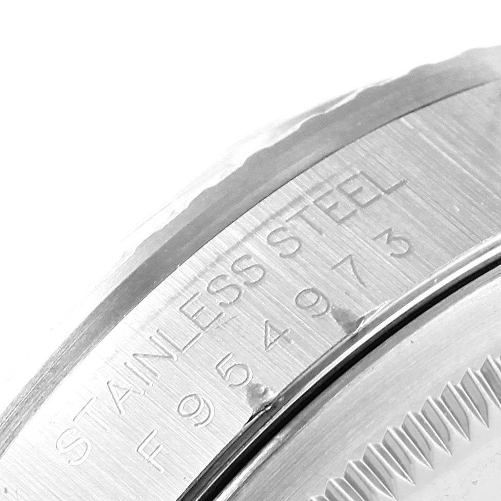 This image shows an angled view of the serial number engraving on the case back of a Rolex Datejust 16220 Men's Stainless Steel Silver Dial 16220 Men's Stainless Steel Silver Dial watch.