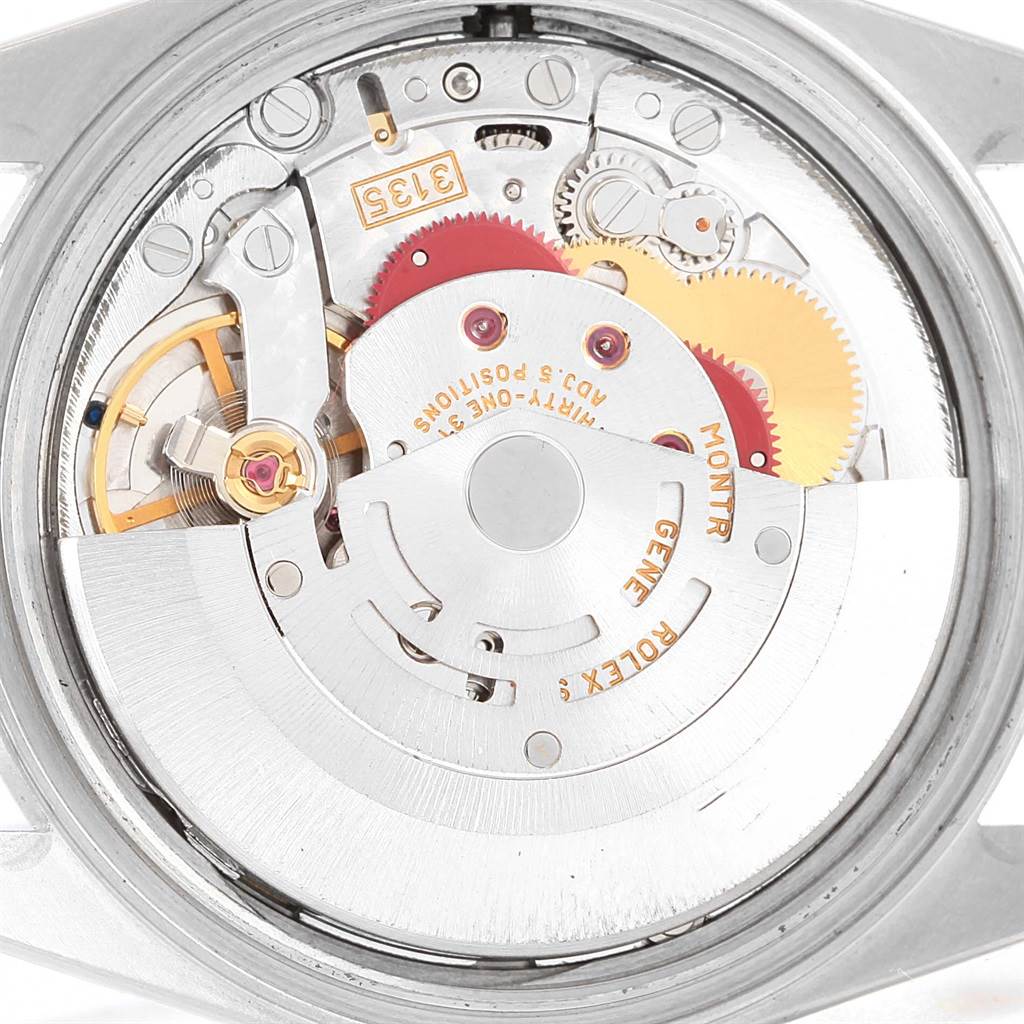 The image shows a close-up of the Rolex Datejust 16200 Men's Stainless Steel White Dial 16200 Men's Stainless Steel White Dial's movement from the back, revealing the mechanical components and rotor.