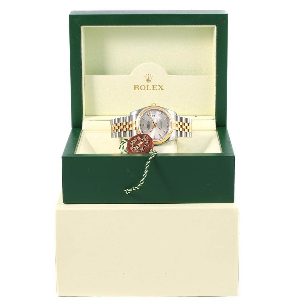 The Rolex Datejust 116203 Men's Stainless Steel Silver Dial 116203 Men's Stainless Steel Silver Dial watch is shown from the front, placed in an open green and cream Rolex box with tags attached.