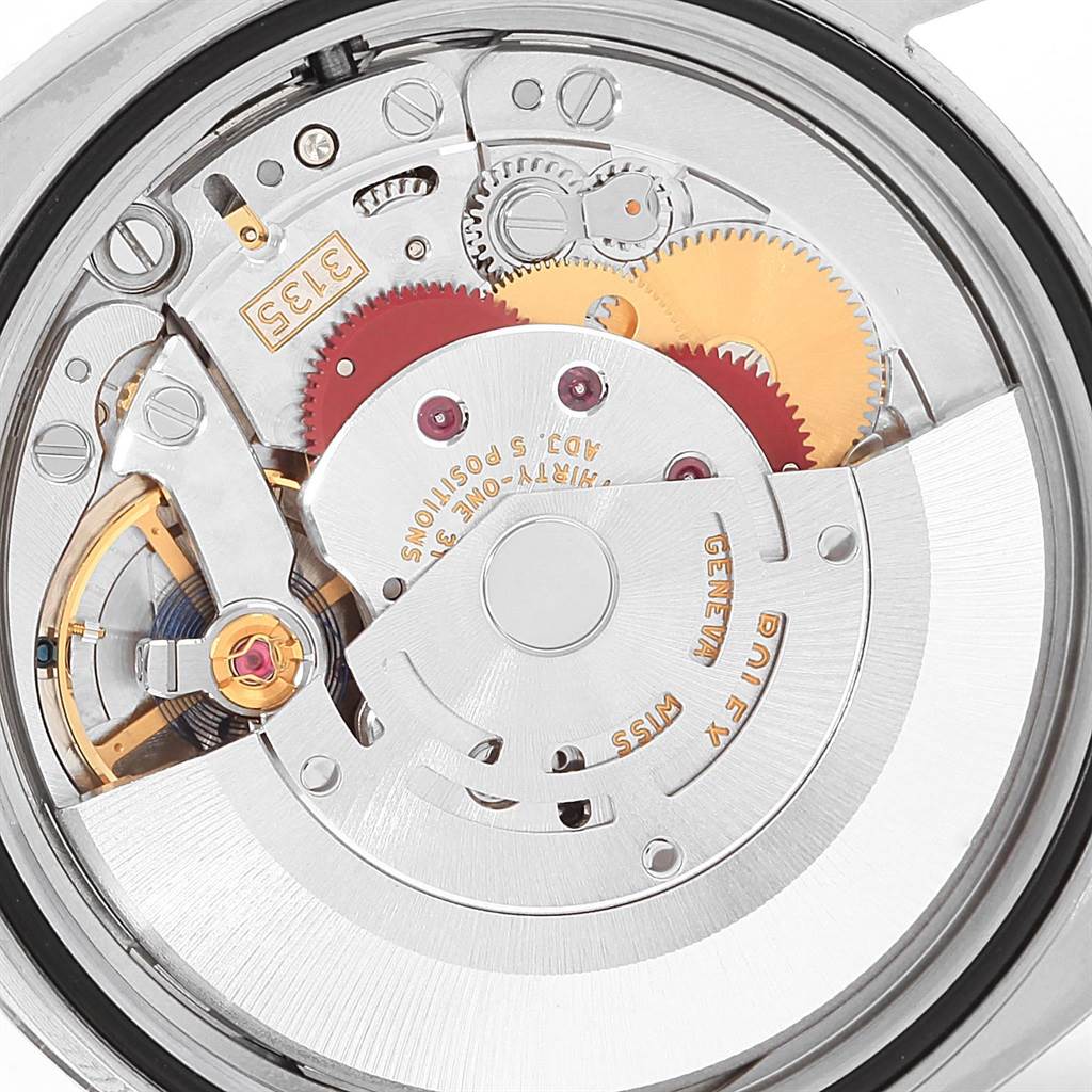 The image shows a close-up view of the Rolex Datejust 116200 Men's Stainless Steel White Dial 116200 Men's Stainless Steel White Dial watch's internal mechanism with visible gears and components.