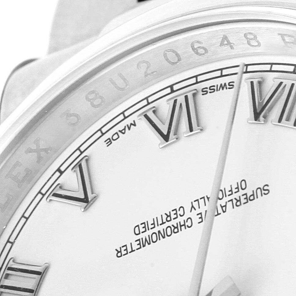The close-up image shows part of the dial and bezel of a Rolex Datejust 116200 Men's Stainless Steel White Dial 116200 Men's Stainless Steel White Dial watch, highlighting the Roman numerals and inscriptions.