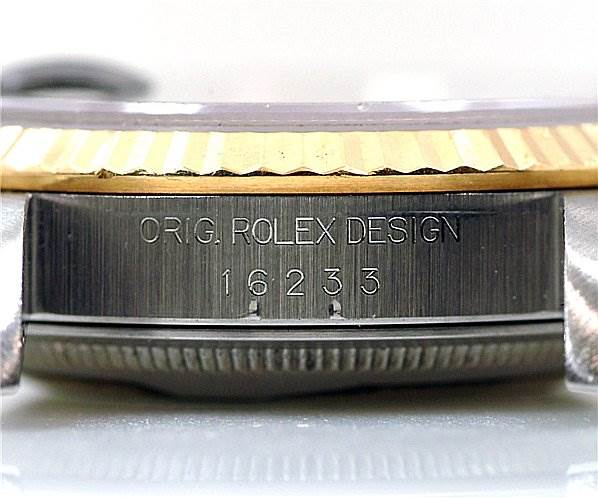 The image shows a close-up of the side of a Rolex Datejust 16233 Men's Stainless Steel Black Dial 16233 Men's Stainless Steel Black Dial watch case with the engraving "ORIG. ROLEX DESIGN 16233."