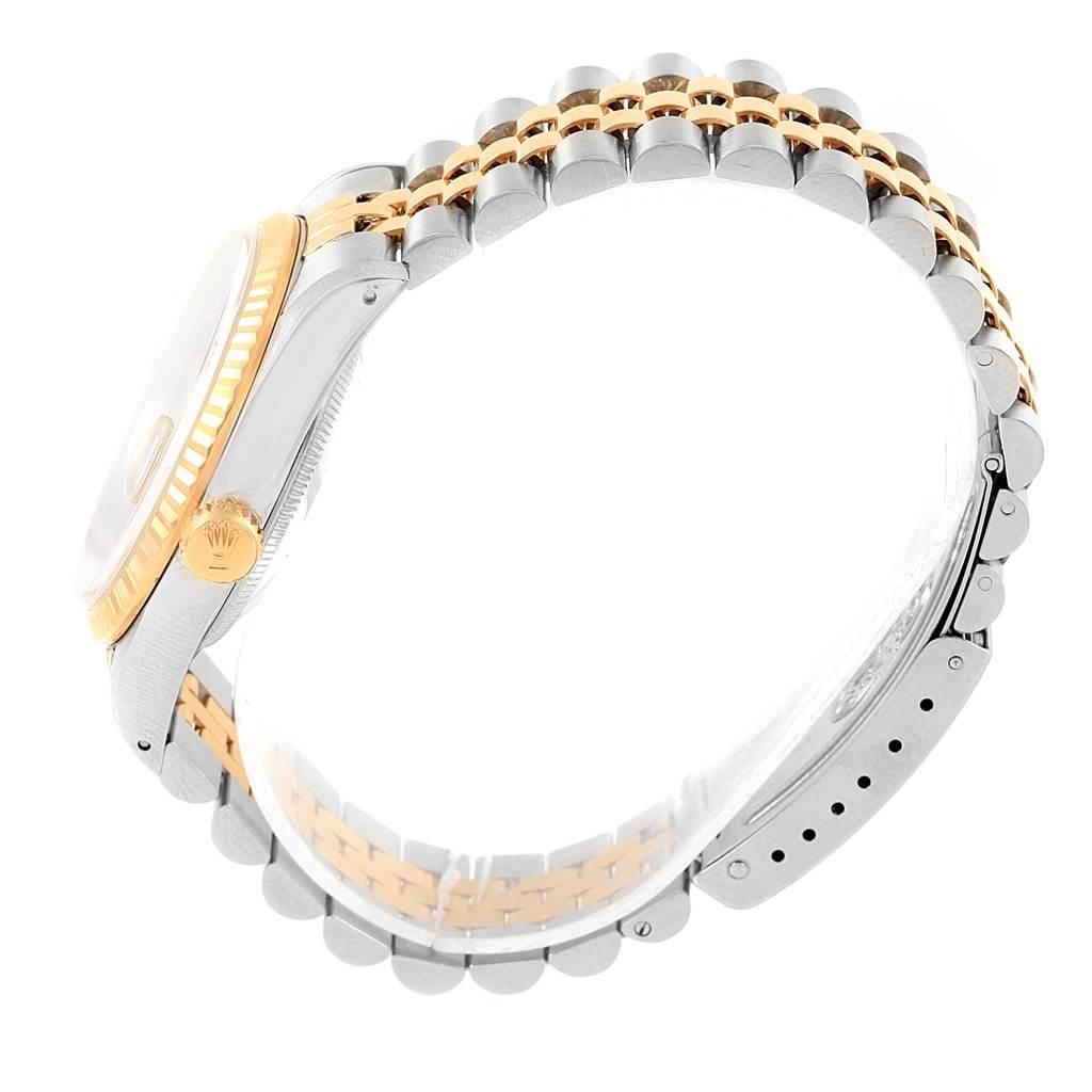 The image shows a side view of a Rolex Datejust 16233 Men's Steel and Gold (two tone) Black Dial 16233 Men's Steel and Gold (two tone) Black Dial watch, highlighting its case, crown, and two-tone bracelet.