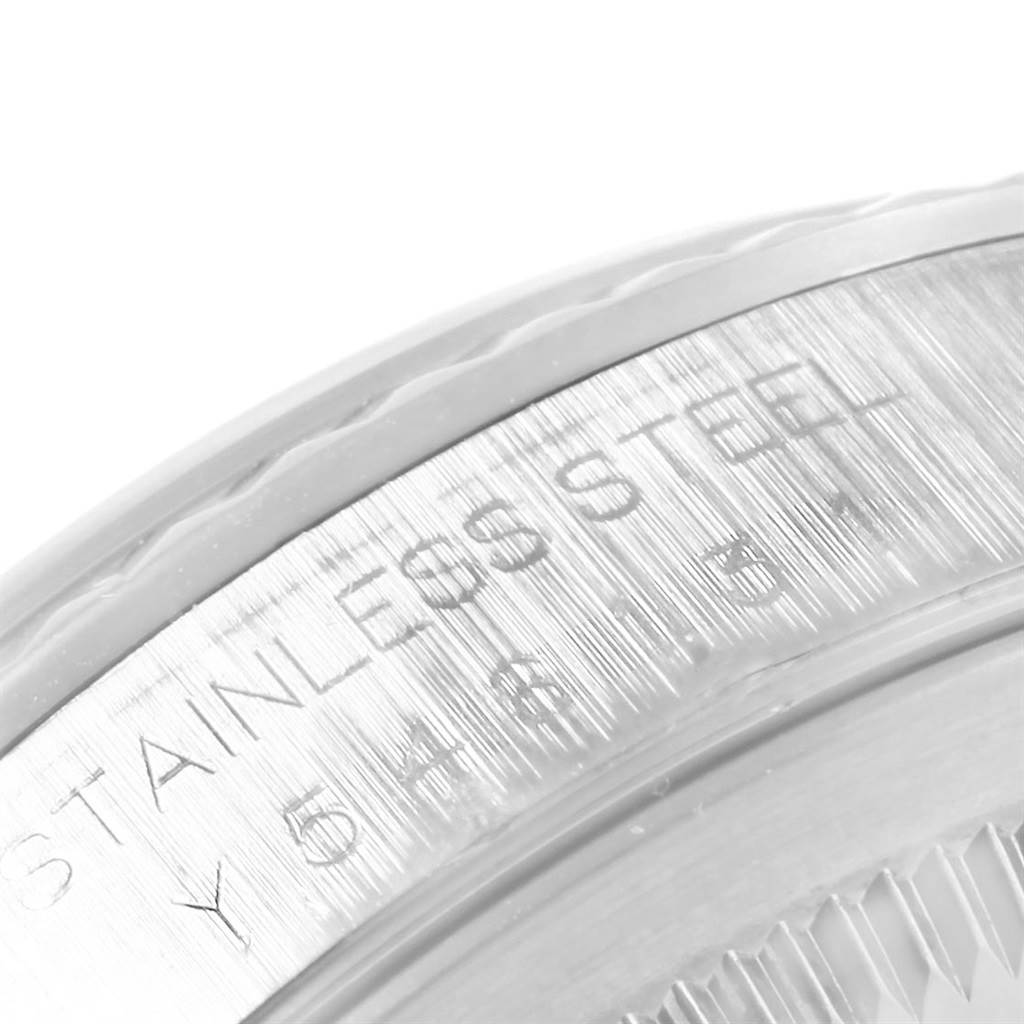 This image shows a close-up of the stainless steel bezel and engraved details of a Rolex Datejust 16234 Men's Stainless Steel Silver Dial 16234 Men's Stainless Steel Silver Dial model watch.