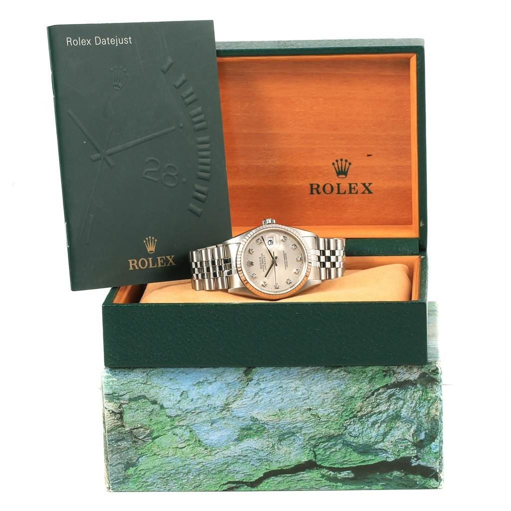The image shows a Rolex Datejust 16234 Men's Stainless Steel Silver Dial 16234 Men's Stainless Steel Silver Dial watch set in its open box, accompanied by a booklet positioned upright.