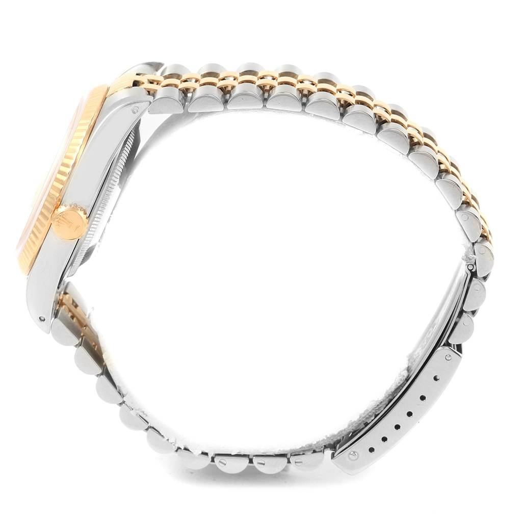 This image shows a side profile of a Rolex Datejust 16233 Men's Steel and Gold (two tone) Champagne Dial 16233 Men's Steel and Gold (two tone) Champagne Dial, highlighting its metal case, gold bezel, and two-tone bracelet.