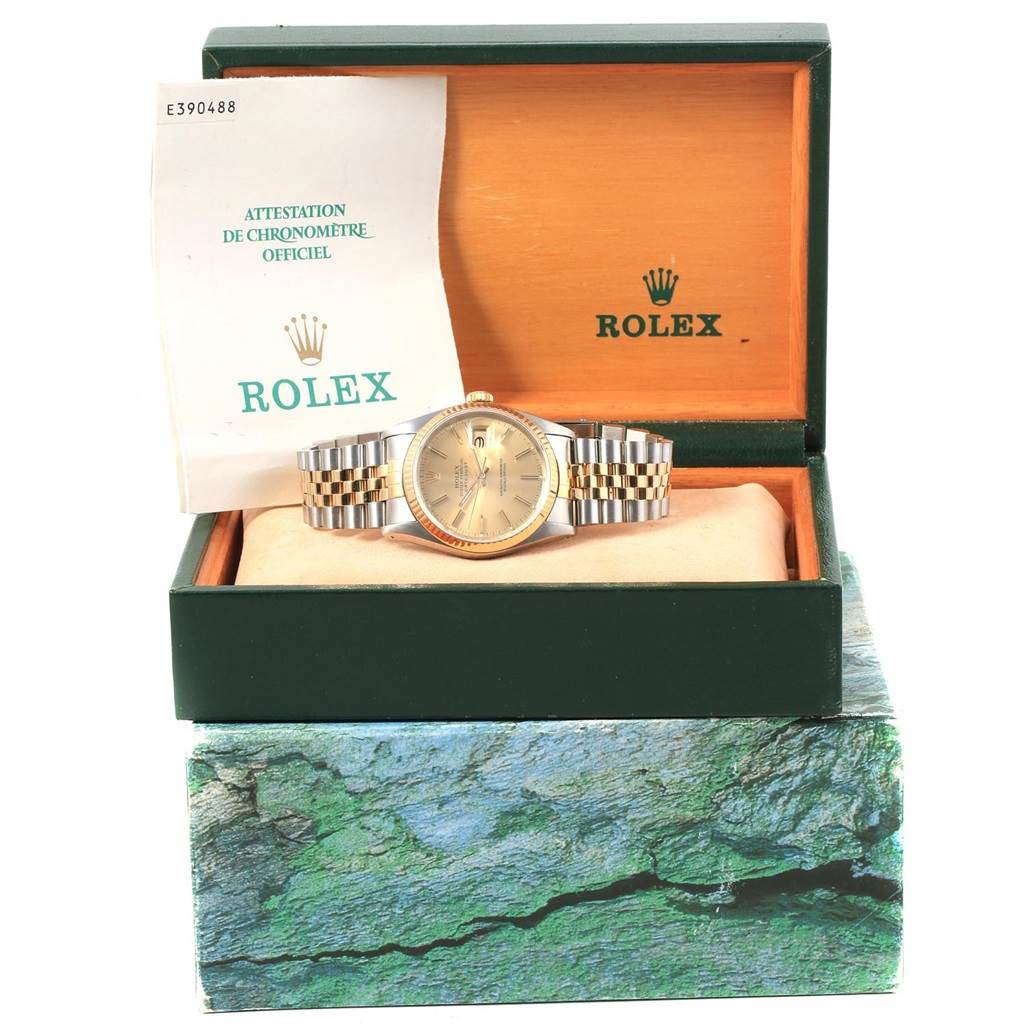 This image shows a Rolex Datejust 16233 Men's Steel and Gold (two tone) Champagne Dial 16233 Men's Steel and Gold (two tone) Champagne Dial watch inside its open presentation box with documentation visible behind the watch.