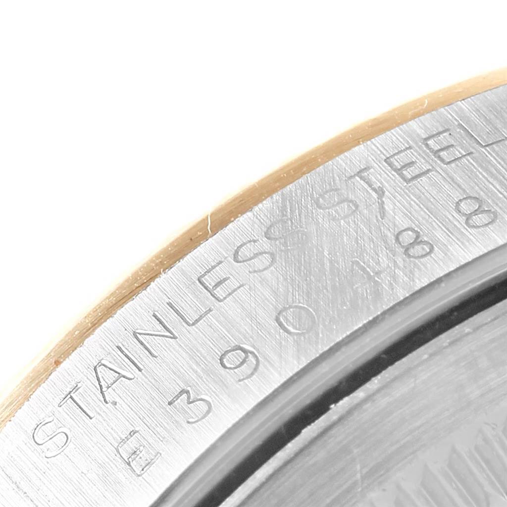 This image shows a close-up of the stainless steel case back edge of a Rolex Datejust 16233 Men's Steel and Gold (two tone) Champagne Dial 16233 Men's Steel and Gold (two tone) Champagne Dial watch.