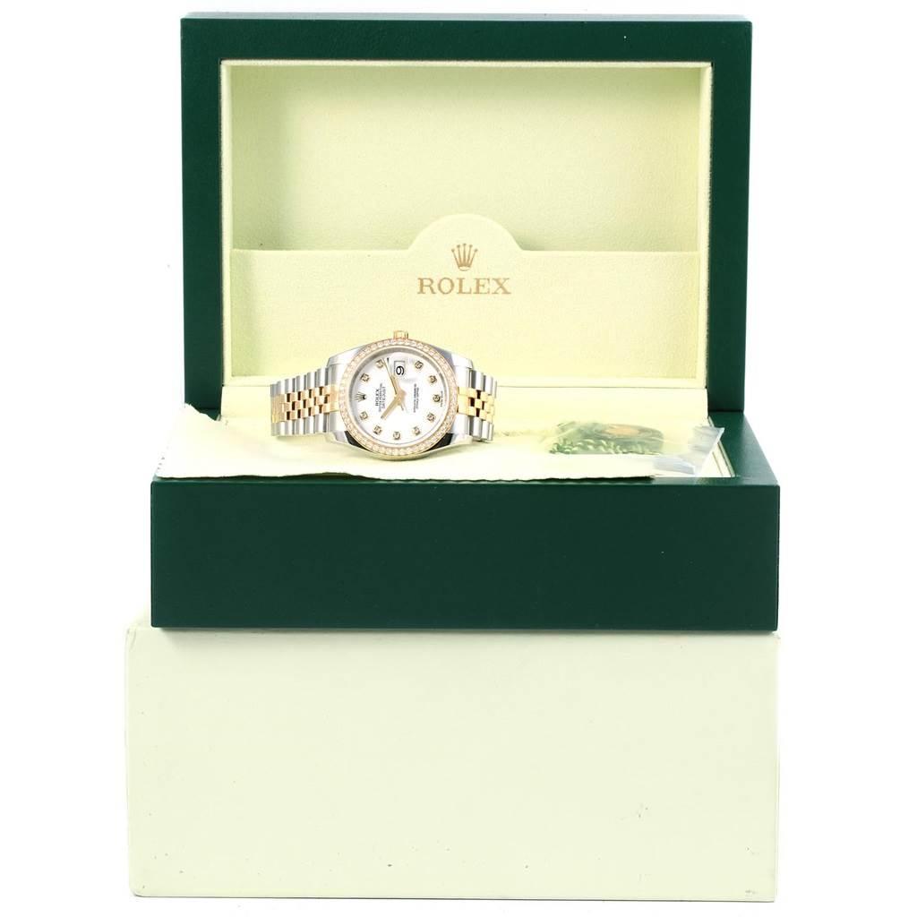 The Rolex Datejust 116243 Stainless Steel White Dial 116243 Stainless Steel White Dial watch is shown from the front, positioned inside an open green and cream box with the brand logo visible.