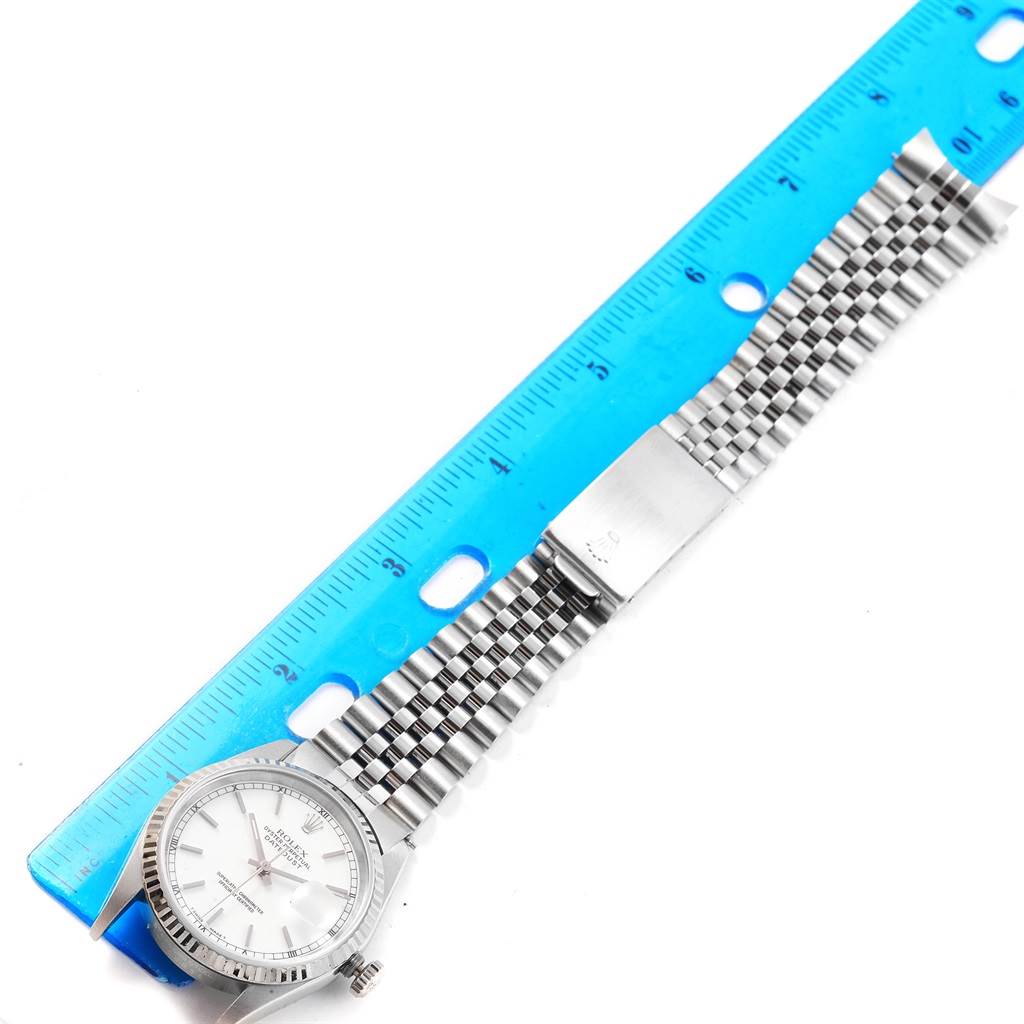 The image shows a Rolex Datejust 16234 Men's Stainless Steel White Dial 16234 Men's Stainless Steel White Dial watch laid flat, with the face, bezel, bracelet, and a ruler for scale visible.