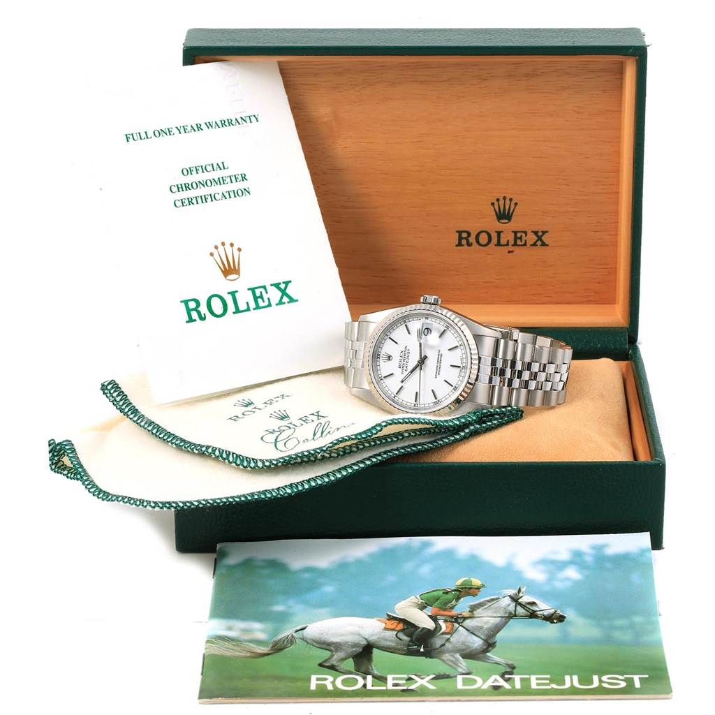 The Rolex Datejust 16234 Men's Stainless Steel White Dial 16234 Men's Stainless Steel White Dial watch is displayed in an open box with its bracelet extended, accompanied by warranty papers and a booklet.