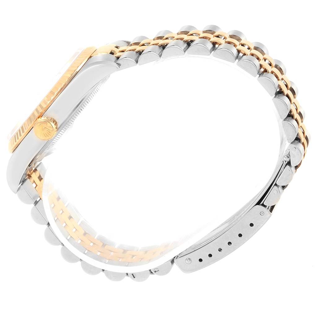 The image shows a side view of a Rolex Datejust 16233 Men's Steel and Gold (two tone) Black Dial 16233 Men's Steel and Gold (two tone) Black Dial watch, highlighting its case, crown, and two-tone metal bracelet.