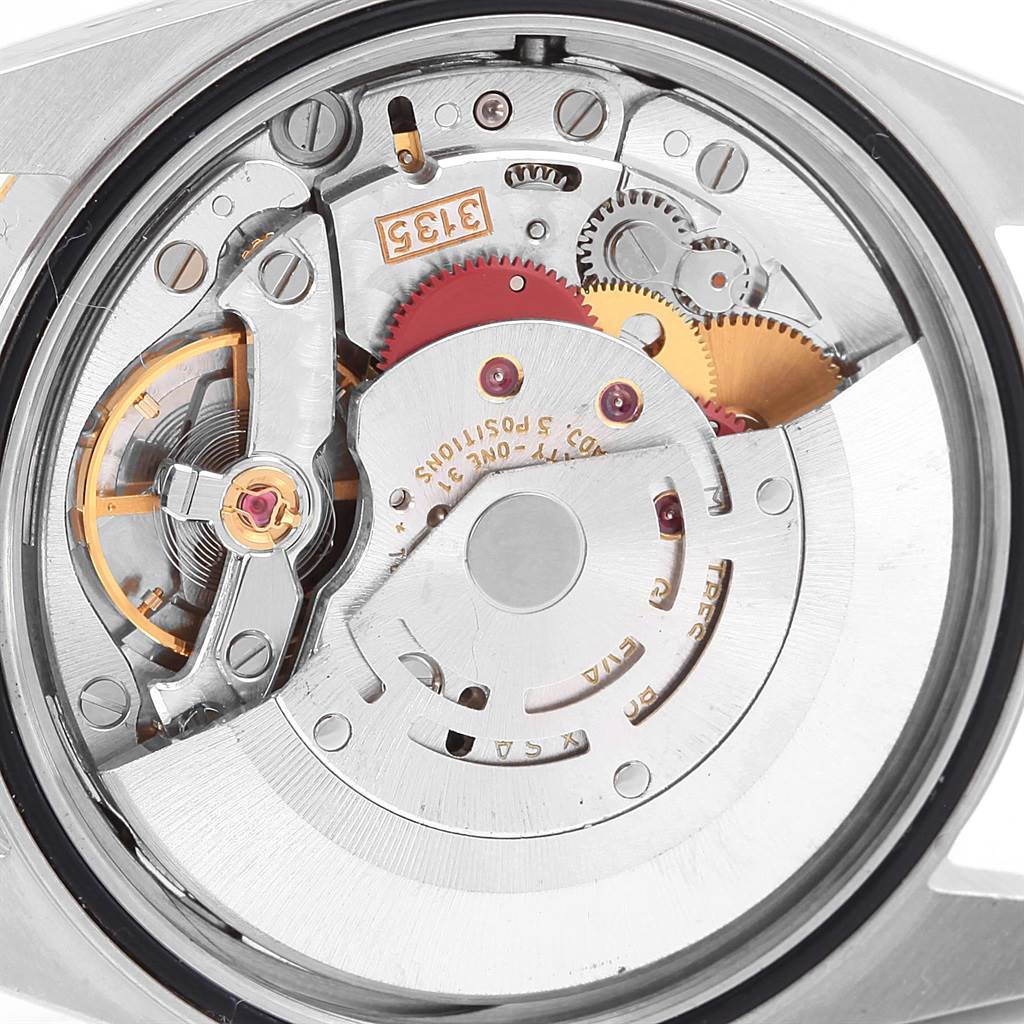 This is an interior view of the Rolex Datejust 16233 Men's Steel and Gold (two tone) Black Dial 16233 Men's Steel and Gold (two tone) Black Dial watch, showing its intricate movement and mechanical components.