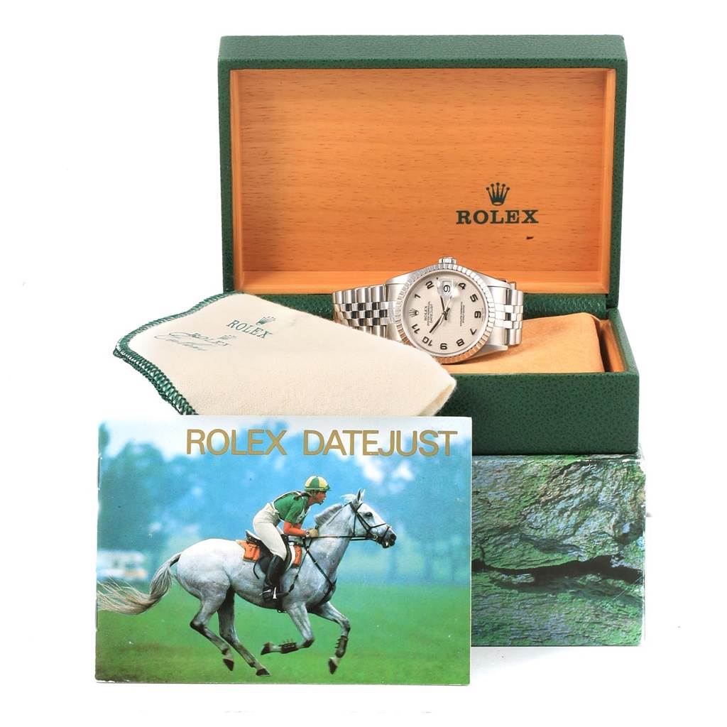 The image shows a Rolex Datejust 16220 Men's Stainless Steel Silver Dial 16220 Men's Stainless Steel Silver Dial watch with its box, a cleaning cloth, and an instruction booklet from a front angle.