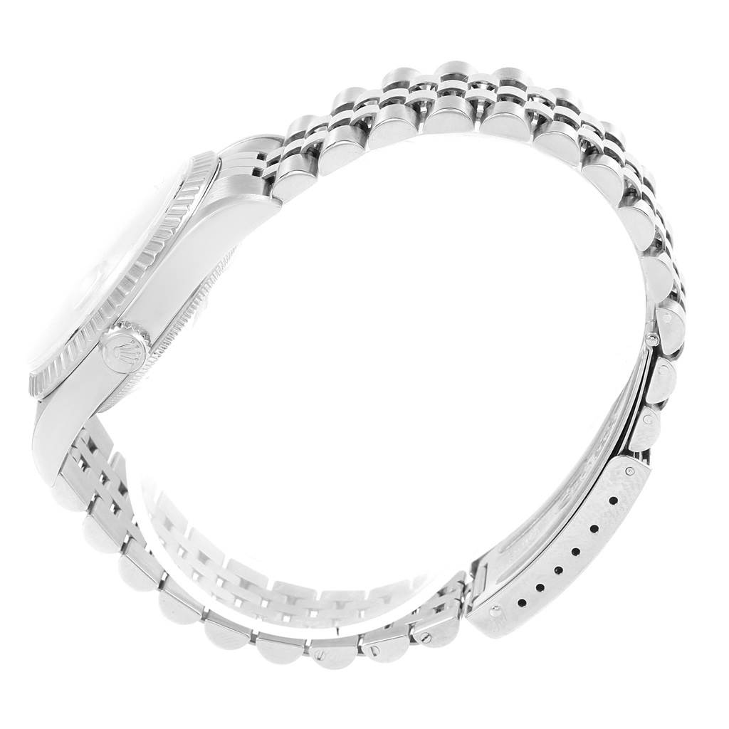 The image shows a side view of a Rolex Datejust 16220 Men's Stainless Steel Silver Dial 16220 Men's Stainless Steel Silver Dial watch, highlighting its case, crown, and bracelet.