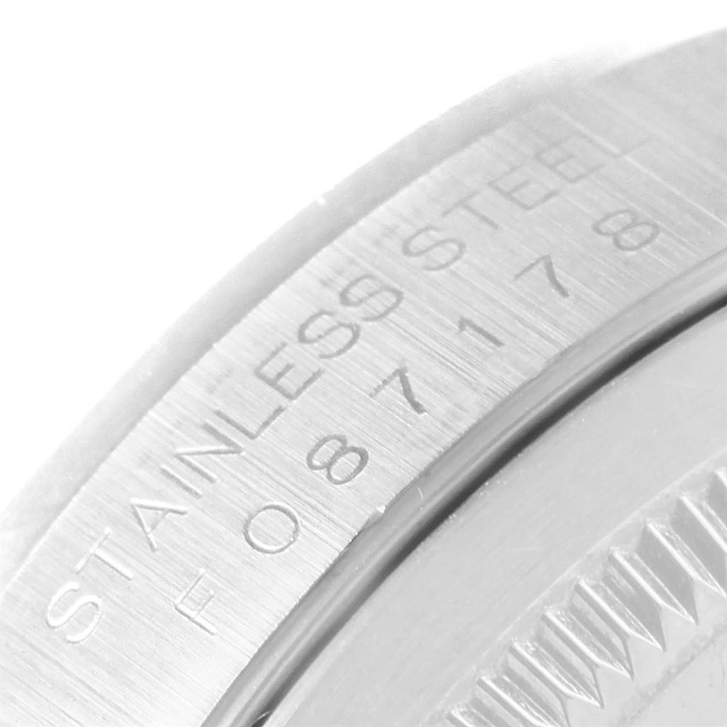 This close-up image shows the engraved serial number and "Stainless Steel" text on the case side of a Rolex Datejust 16200 Men's Stainless Steel Silver Dial 16200 Men's Stainless Steel Silver Dial watch.