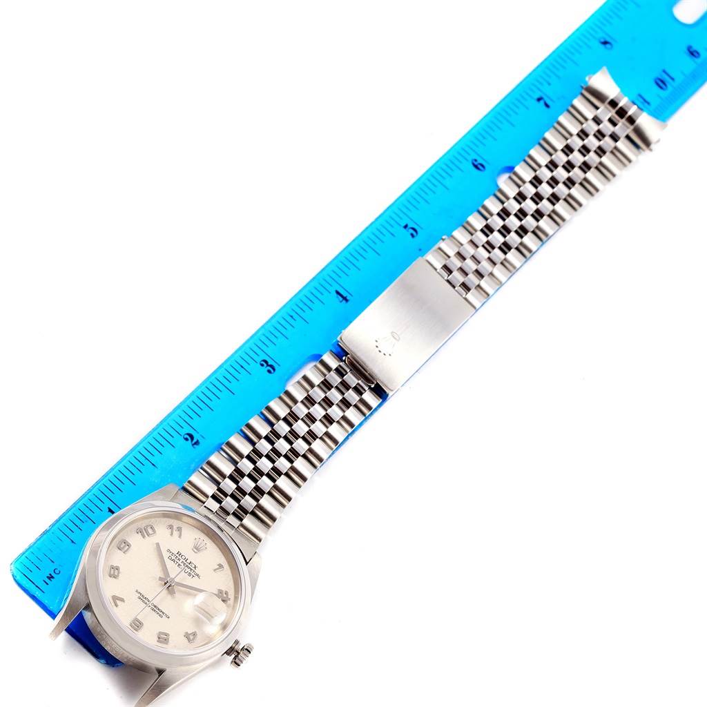 The image shows a Rolex Datejust 16200 Men's Stainless Steel Silver Dial 16200 Men's Stainless Steel Silver Dial watch laid flat with a blue ruler measuring its length, highlighting the face and bracelet.