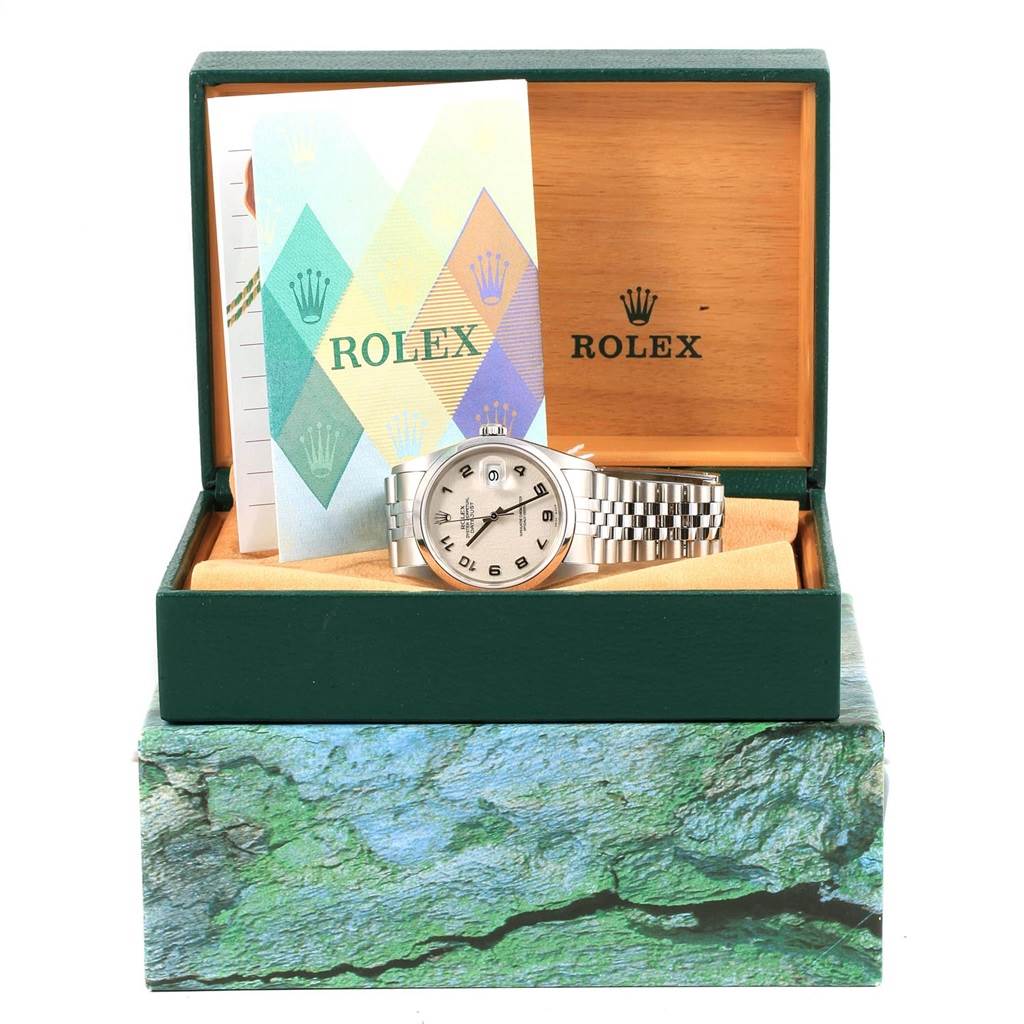 The Rolex Datejust 16200 Men's Stainless Steel Silver Dial 16200 Men's Stainless Steel Silver Dial watch is shown inside its green box along with warranty papers, viewed from the front.