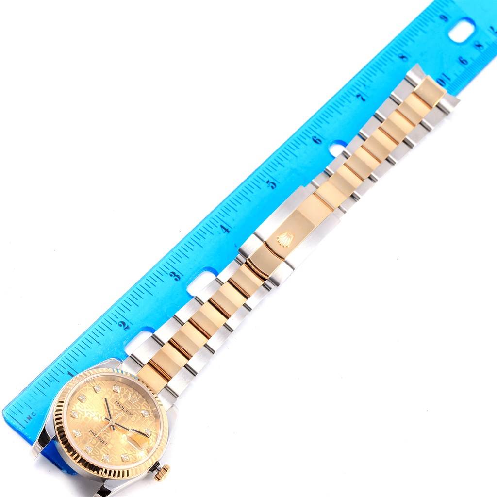 The image shows a Rolex Datejust 116233 Men's Stainless Steel Champagne Dial 116233 Men's Stainless Steel Champagne Dial watch band and face placed next to a blue ruler for measurement.