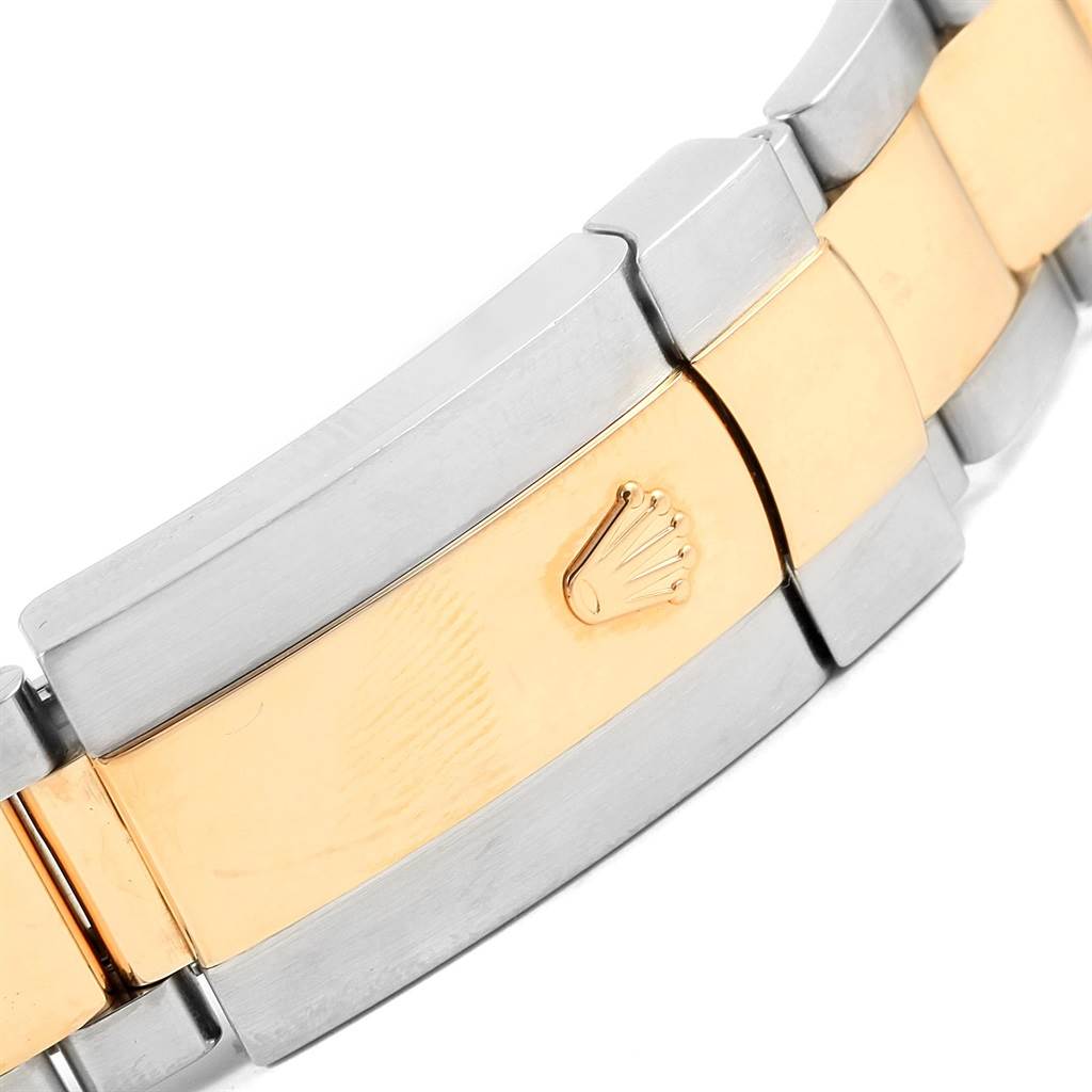 The image shows a close-up of the clasp on a Rolex Datejust 116233 Men's Stainless Steel Champagne Dial 116233 Men's Stainless Steel Champagne Dial watch bracelet, featuring a two-tone metal design with the Rolex logo.