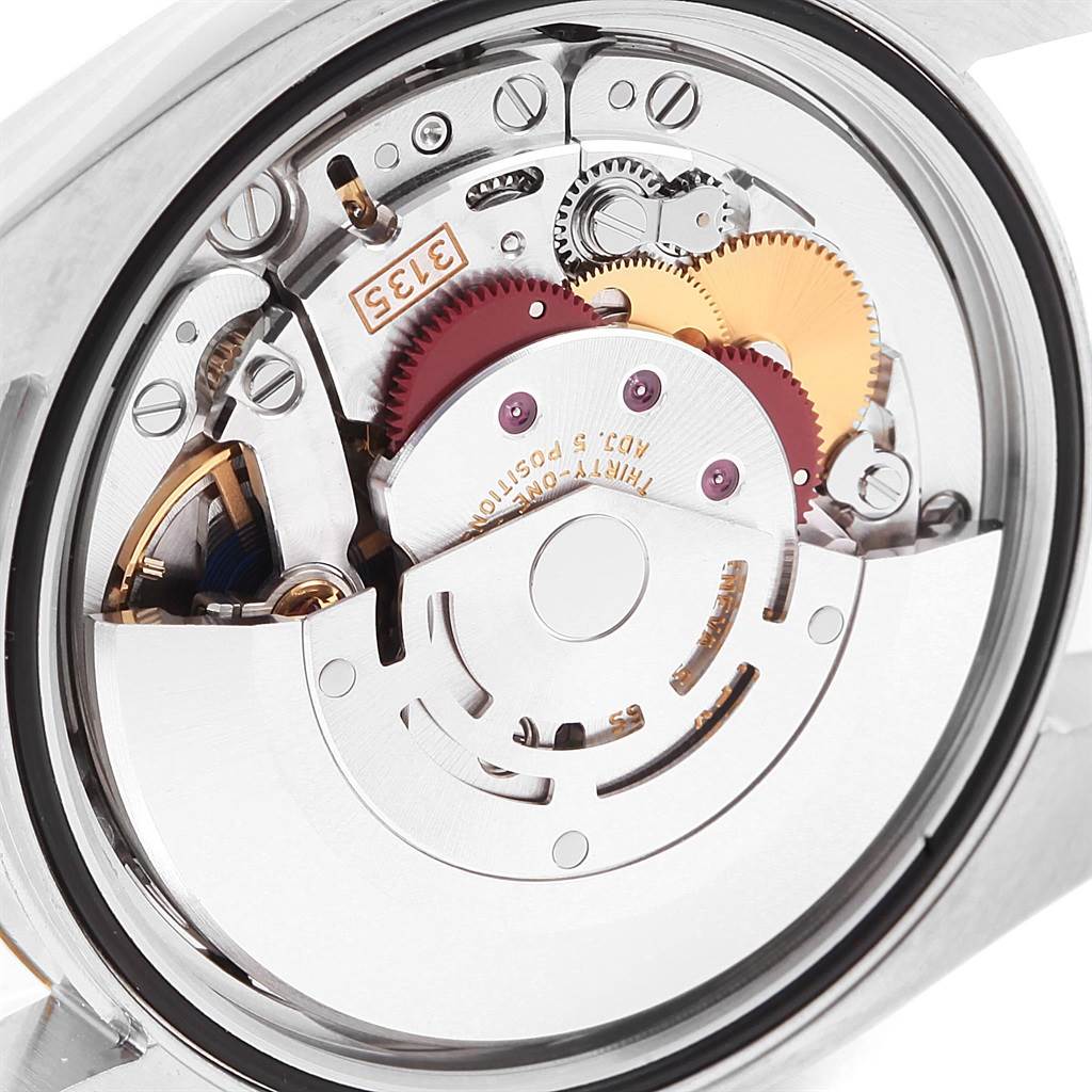 This image shows the internal mechanism of a Rolex Datejust 116233 Men's Stainless Steel Silver Dial 116233 Men's Stainless Steel Silver Dial watch from a rear angle, highlighting its intricate gears and components.