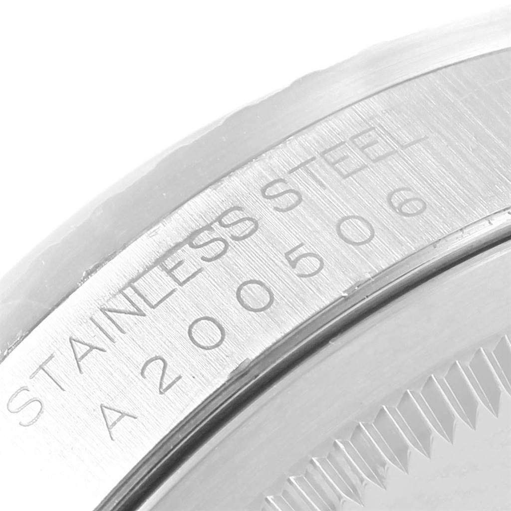 Close-up of the serial number and stainless steel marking on the case back of a Rolex Datejust 16220 Men's Stainless Steel Silver Dial 16220 Men's Stainless Steel Silver Dial watch.