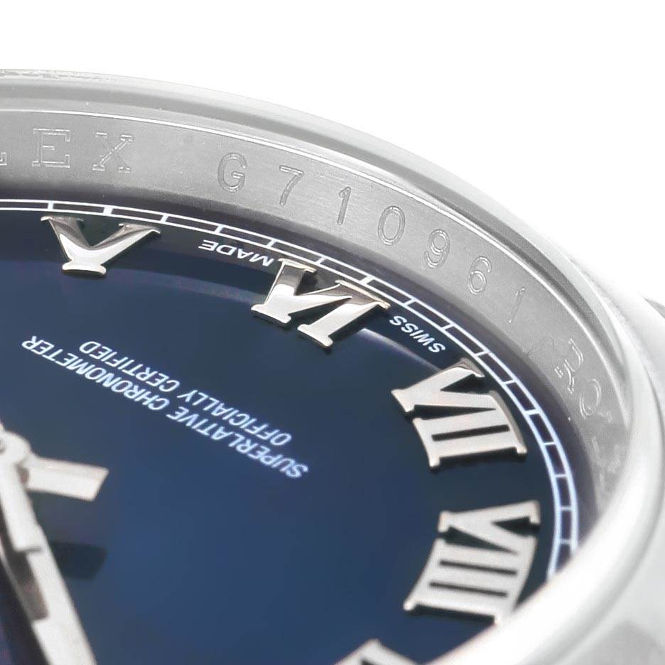 This close-up image shows the dial and engraved serial number on the bezel of a Rolex Datejust 116200 Men's Stainless Steel Blue Dial 116200 Men's Stainless Steel Blue Dial watch.