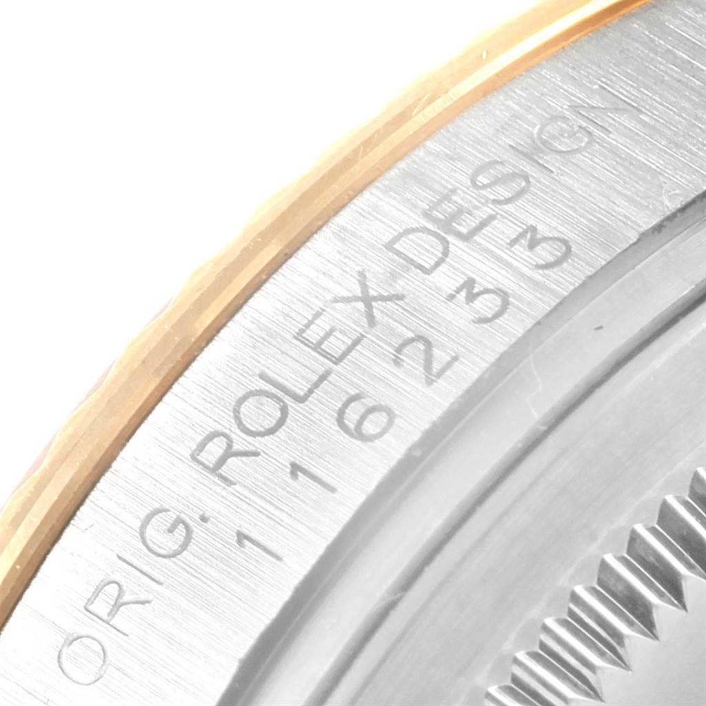 This close-up image shows the engraved details on the side of the Rolex Datejust 116233 Men's Stainless Steel Mother of Pearl Dial 116233 Men's Stainless Steel Mother of Pearl Dial watch case.