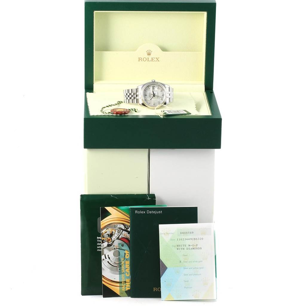 The image shows a Rolex Datejust 116234 Men
s Stainless Steel Mother of Pearl Dial 116234 Men
s Stainless Steel Mother of Pearl Dial watch in its open green and cream box, along with related booklets and tags.