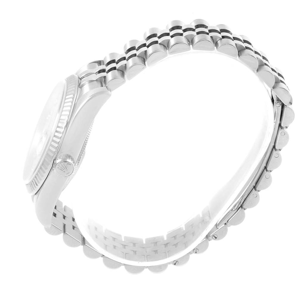 The image shows a side view of a Rolex Datejust 116234 Men
s Stainless Steel Mother of Pearl Dial 116234 Men
s Stainless Steel Mother of Pearl Dial watch focusing on the bracelet, crown, and part of the bezel.