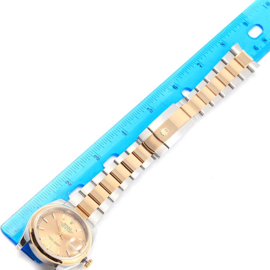 The image shows a Rolex Datejust 116203 Men
s Stainless Steel Champagne Dial 116203 Men
s Stainless Steel Champagne Dial watch laid flat next to a ruler, displaying the face and full bracelet.
