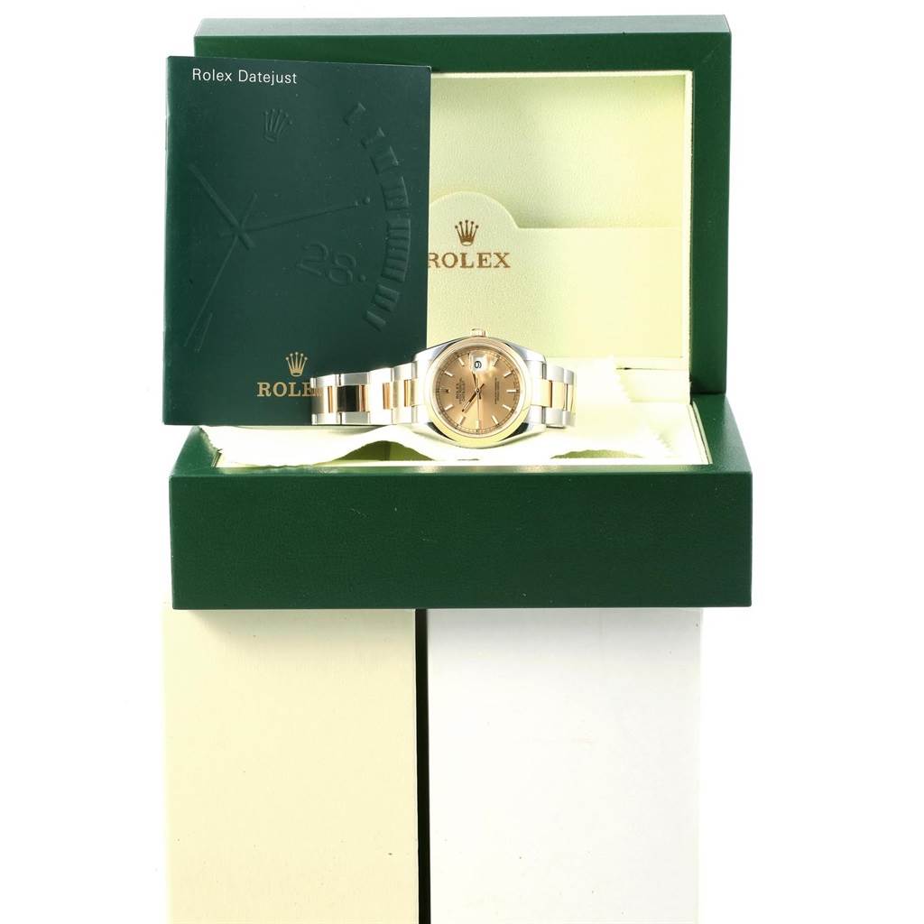 The Rolex Datejust 116203 Men
s Stainless Steel Champagne Dial 116203 Men
s Stainless Steel Champagne Dial watch is shown in its box with a green booklet, viewed from the front.