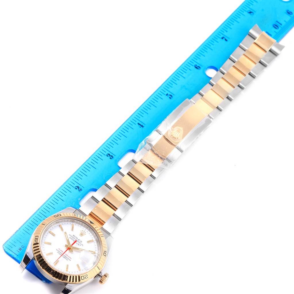 The image shows a top-down view of a Rolex Datejust 116263 Men's Stainless Steel White Dial 116263 Men's Stainless Steel White Dial watch, focusing on the face and band, alongside a blue ruler for scale.