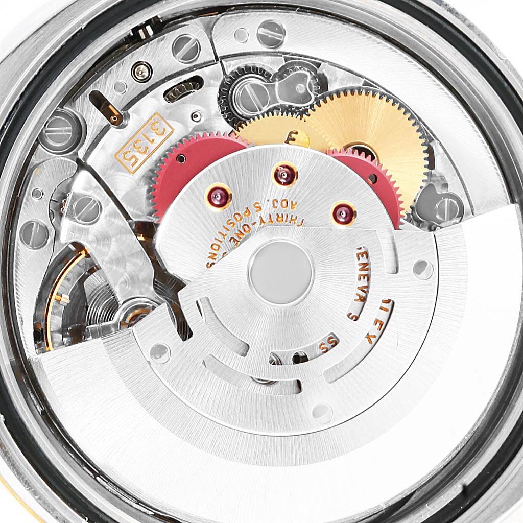 This is a close-up view of the movement mechanism of a Rolex Datejust 116233 Men's Stainless Steel Champagne Dial 116233 Men's Stainless Steel Champagne Dial watch, showing gears and the rotor.
