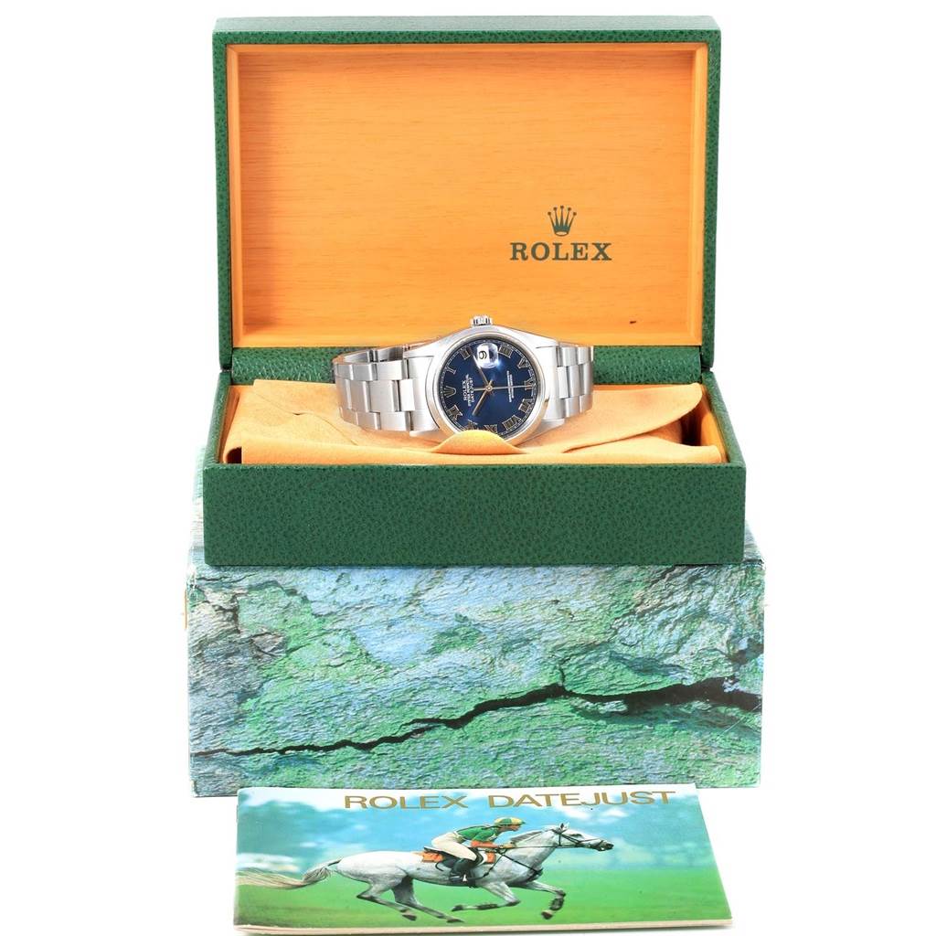 The Rolex Datejust 16200 Men's Stainless Steel Blue Dial 16200 Men's Stainless Steel Blue Dial watch is shown in its open box, displaying the dial, bracelet, and accessory booklet in front.