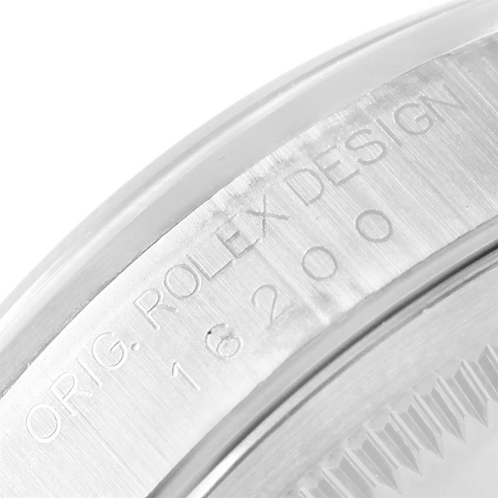 The image shows a close-up of the case engraving on a Rolex Datejust 16200 Men's Stainless Steel Blue Dial 16200 Men's Stainless Steel Blue Dial model, displaying "ORIG. ROLEX DESIGN" and the model number.