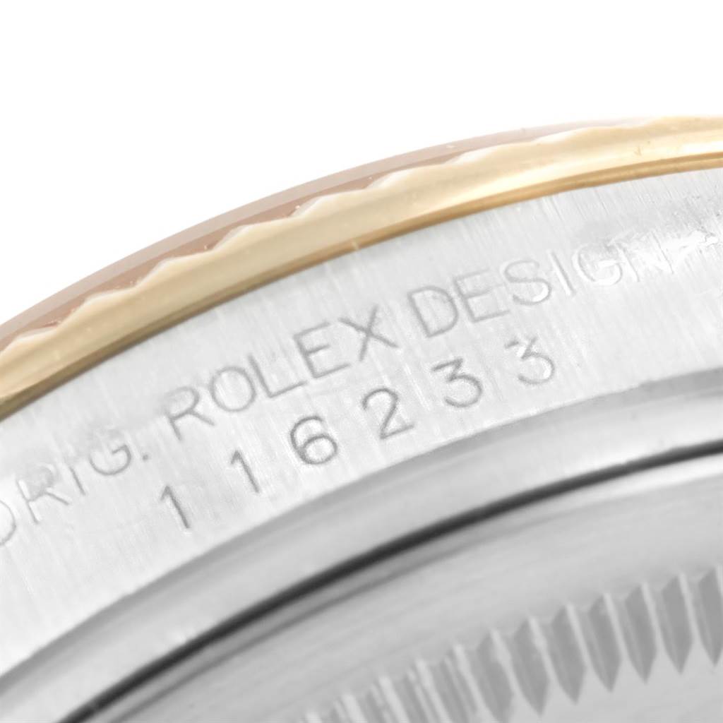 The image shows a close-up of the side engraving on a Rolex Datejust 116233 Men's Stainless Steel White Dial 116233 Men's Stainless Steel White Dial watch, with part of the bezel visible.