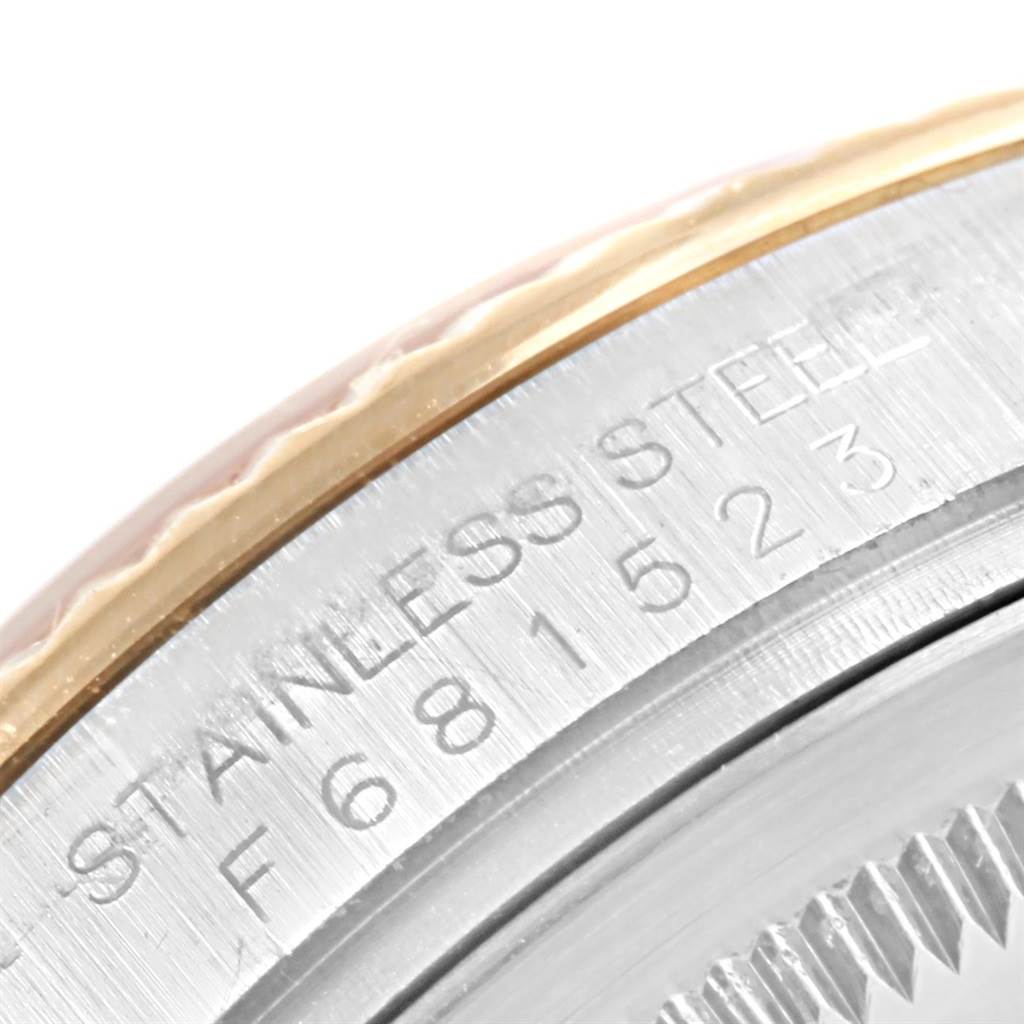 This image shows a close-up of the side of a Rolex Datejust 116233 Men's Stainless Steel White Dial 116233 Men's Stainless Steel White Dial watch case, displaying the engraving and part of the bezel.