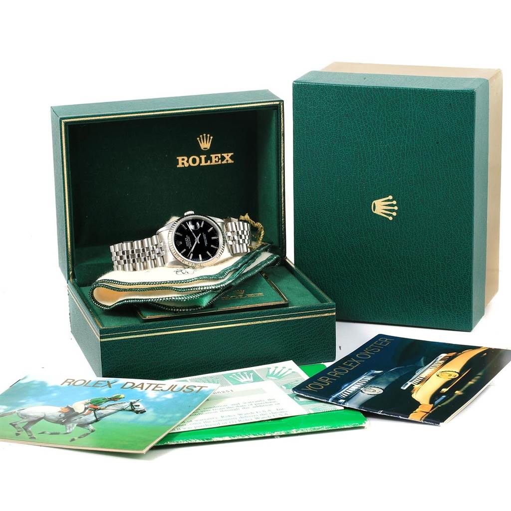 The image shows a Rolex Datejust 16234 Men's Stainless Steel Black Dial 16234 Men's Stainless Steel Black Dial watch and its accessories, including manuals, in an open green Rolex box.