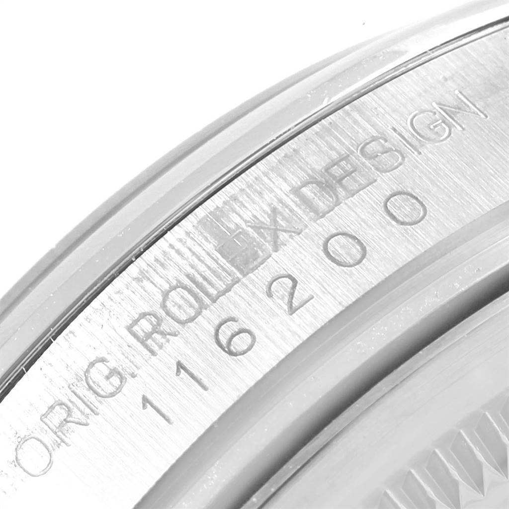 The image shows a close-up of the Datejust Rolex watch's casing edge with engraved model details.