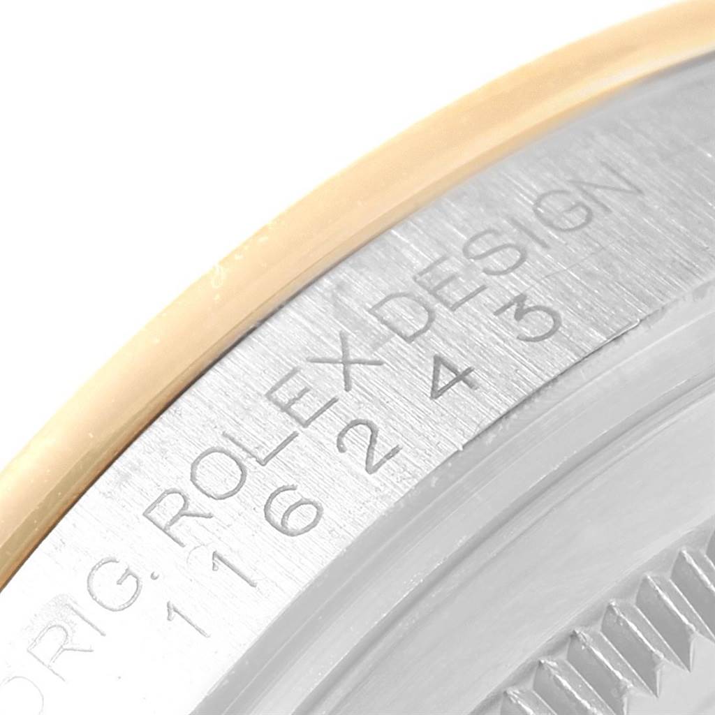 This close-up image showcases the engraved outer rim of the Rolex Datejust 116243 Women's Stainless Steel Champagne Dial 116243 Women's Stainless Steel Champagne Dial watch model, including part of the bezel.