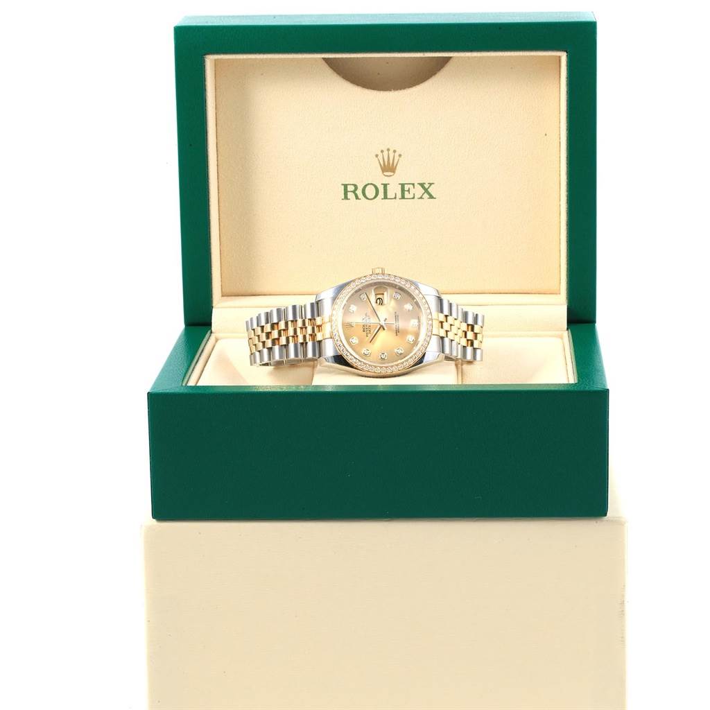 The Rolex Datejust 116243 Women's Stainless Steel Champagne Dial 116243 Women's Stainless Steel Champagne Dial watch is shown from a front angle inside its green and cream presentation box.