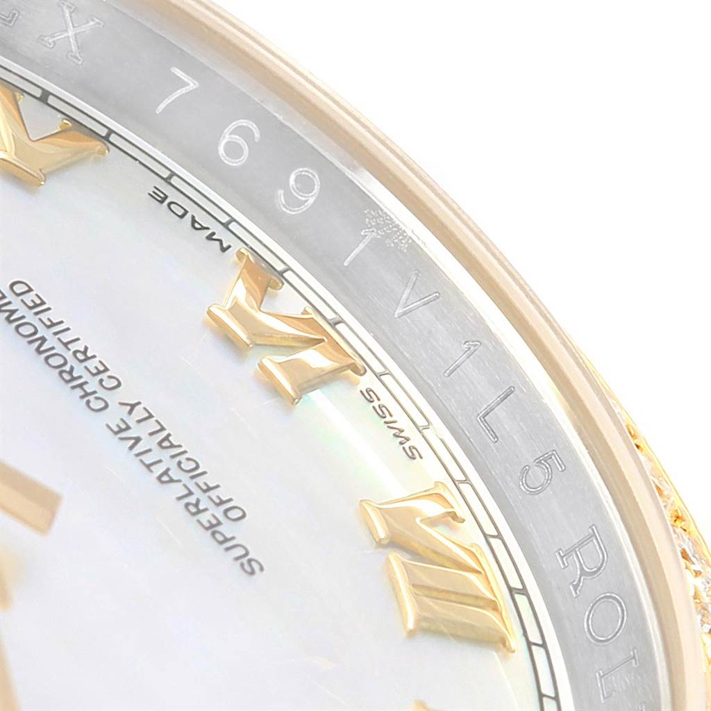 Close-up of a Rolex Datejust 116243 Men's Stainless Steel Mother of Pearl Dial 116243 Men's Stainless Steel Mother of Pearl Dial watch showing the bezel with engraved numerals and part of the dial with Roman numerals.