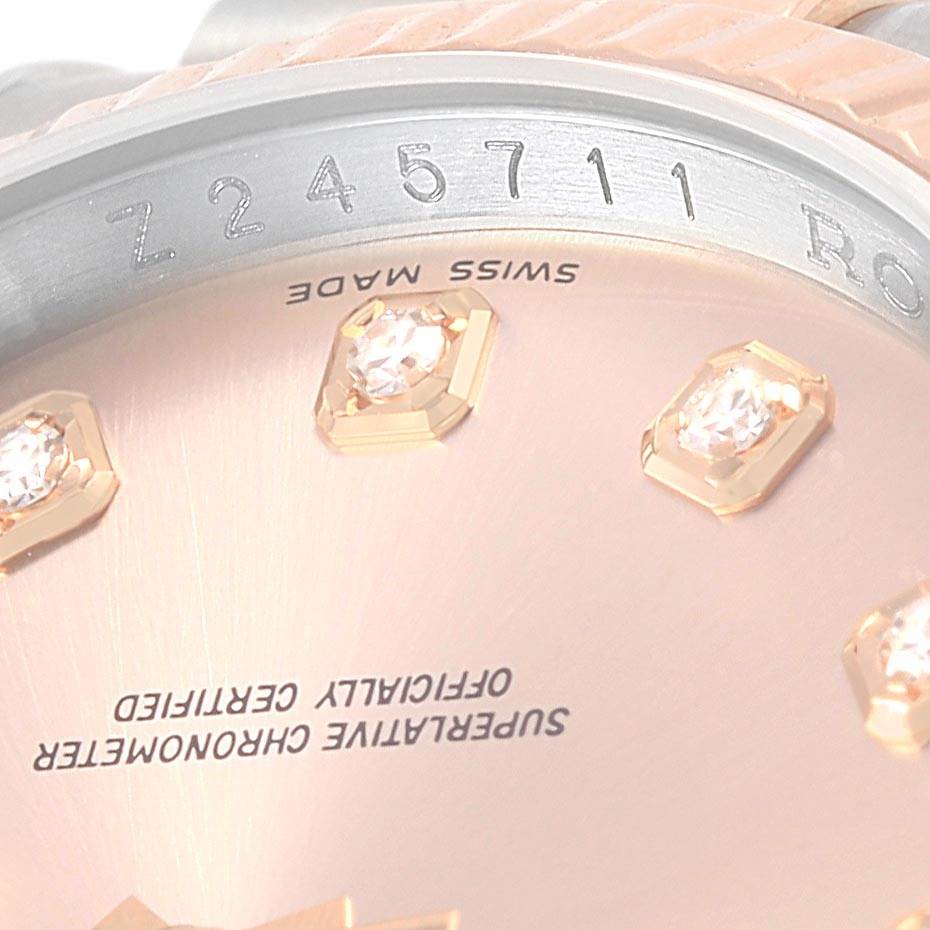 This close-up image shows the bezel and part of the dial of a Rolex Datejust 116231 Steel and Gold (two tone) Pink Dial 116231 Steel and Gold (two tone) Pink Dial watch, including some diamond hour markers.