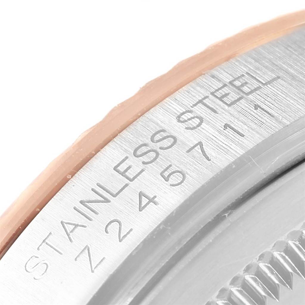 This is a close-up view of the side of a Rolex Datejust 116231 Steel and Gold (two tone) Pink Dial 116231 Steel and Gold (two tone) Pink Dial watch, showing part of the bezel and case with the "STAINLESS STEEL" engraving.