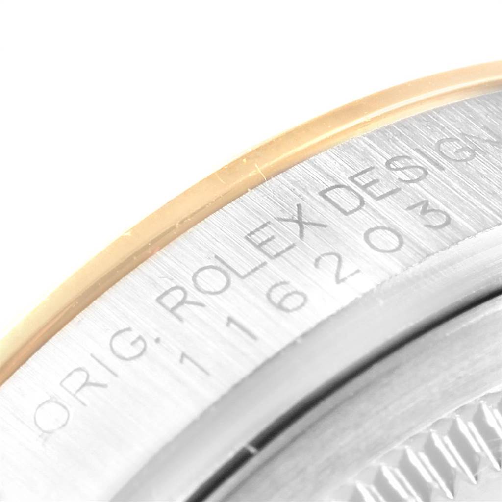 The image shows a close-up of the side of a Rolex Datejust 116203 Men's Steel and Gold (two tone) Black Dial 116203 Men's Steel and Gold (two tone) Black Dial watch case, focusing on the engraved model number and brand.