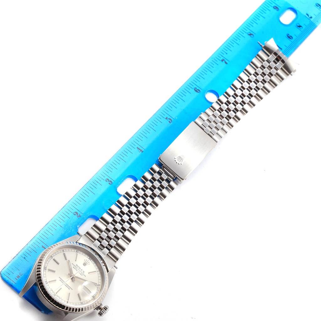 The image shows a Rolex Datejust 16234 Men's Stainless Steel Silver Dial 16234 Men's Stainless Steel Silver Dial watch laid flat next to a ruler, displaying its face, bracelet, and clasp from a top-down angle.