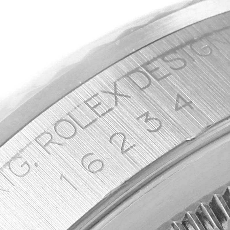 This close-up image shows the engraved bezel and part of the case of a Rolex Datejust 16234 Men's Stainless Steel Black Dial 16234 Men's Stainless Steel Black Dial watch.