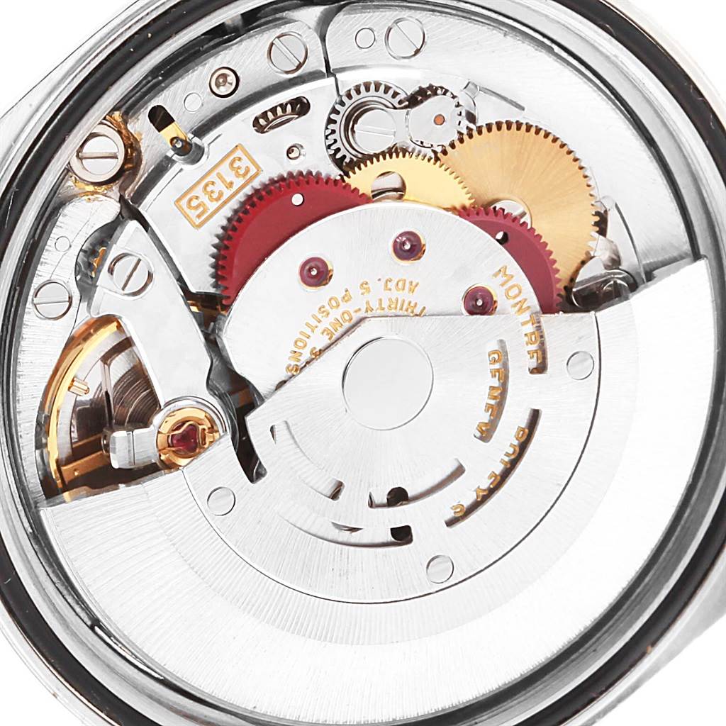 The image shows a close-up of the internal mechanical movement of a Rolex Datejust 16234 Men's Stainless Steel Black Dial 16234 Men's Stainless Steel Black Dial watch, highlighting the gears and rotor.