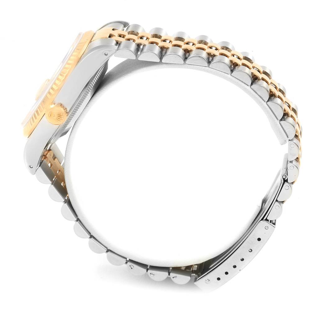 The side view of the Rolex Datejust 16233 Men's Steel and Gold (two tone) Champagne Dial 16233 Men's Steel and Gold (two tone) Champagne Dial watch showcases the jubilee bracelet and crown, highlighting its two-tone gold and silver design.